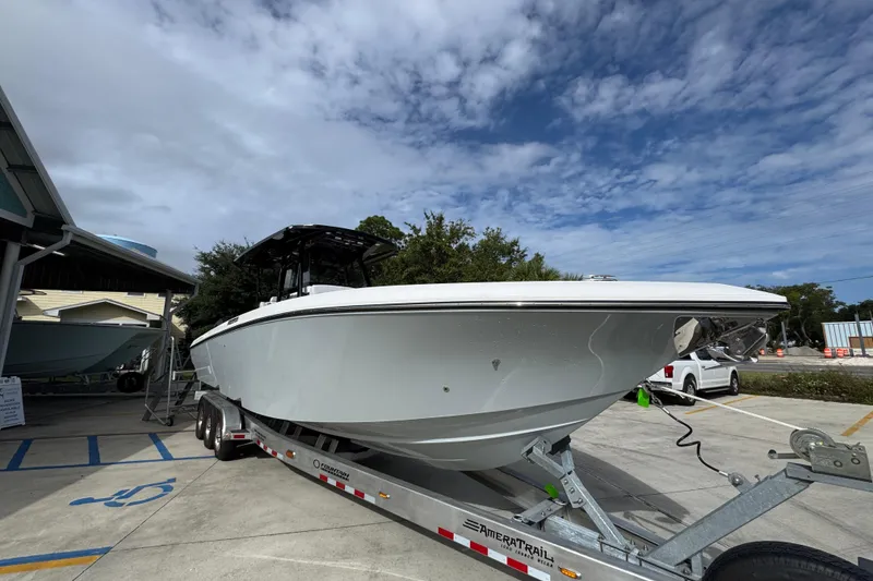 Slide: The Image of 2026 Fountain 34 Tournament Edition boat on trailer under cloudy sky. - 7