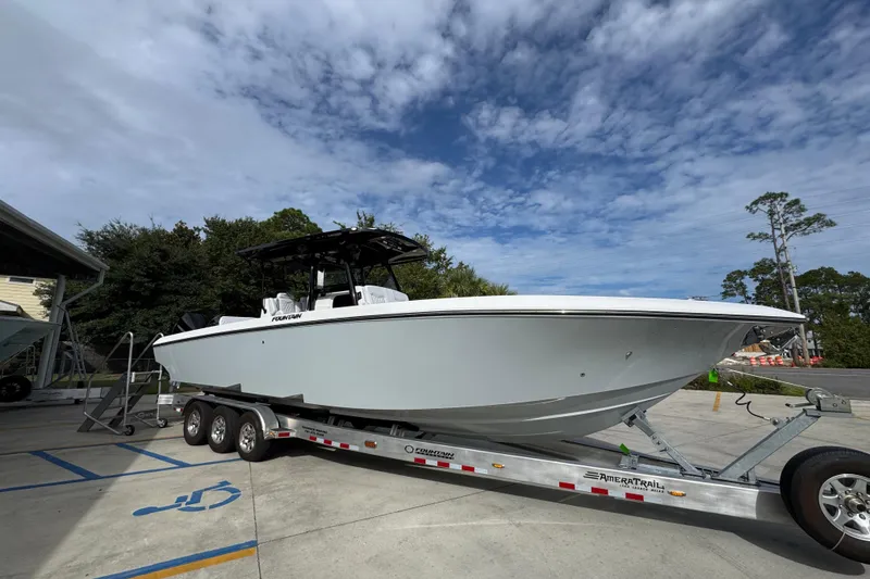 Slide: The Image of 2026 Fountain 34 Tournament Edition boat on trailer under cloudy sky. - 8