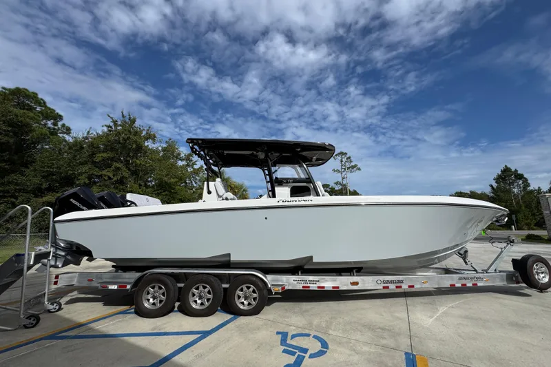 Slide: The Image of 2026 Fountain 34 Tournament Edition boat on trailer under blue sky. - 9