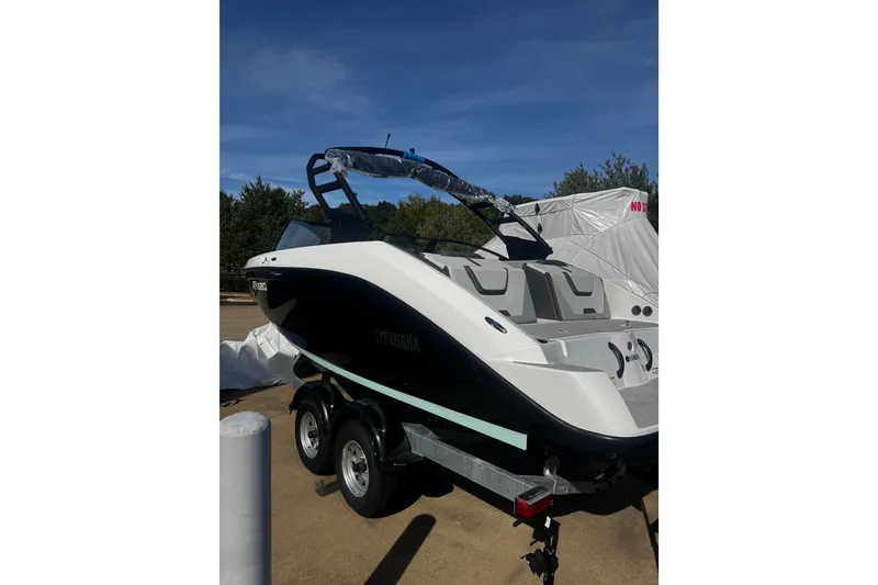 Slide: The Image of 2026 Yamaha Boats AR220 on trailer, sleek design, parked outdoors under clear sky. - 10