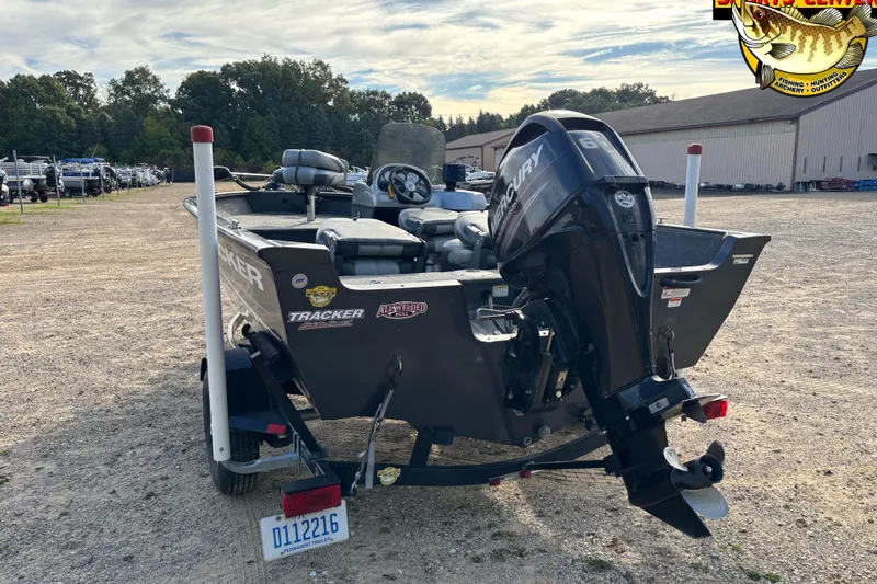 Slide: The Image of 2014 Tracker Pro Guide V-16 SC boat with Mercury engine, parked outdoors. - 3