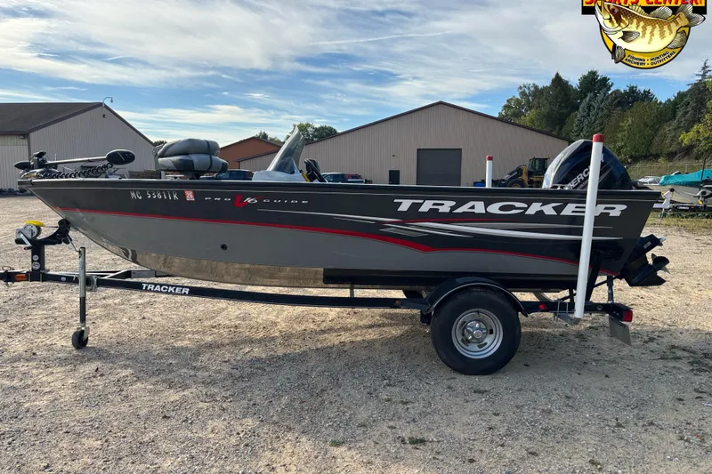 Slide: The Image of 2014 Tracker Pro Guide V-16 SC boat on trailer, parked outdoors. - 4