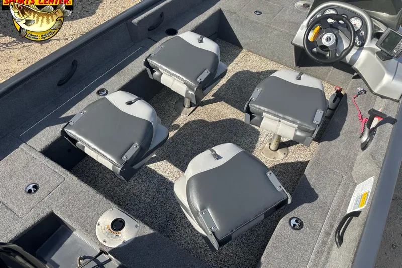 Slide: The Image of 2014 Tracker Pro Guide V-16 SC boat interior with four seats and steering console. - 6