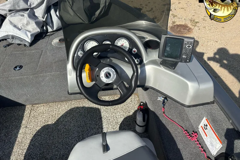 Slide: The Image of 2014 Tracker Pro Guide V-16 SC boat dashboard with steering wheel and fish finder. - 9