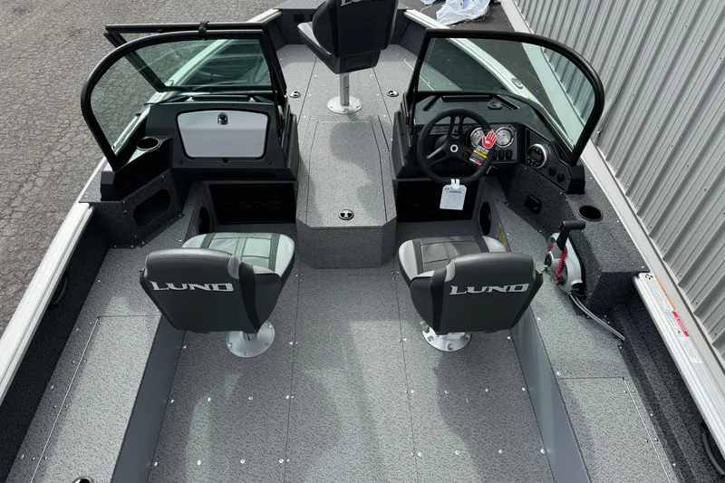 Slide: The Image of 2026 Lund 1800 Explorer Sport boat interior with dual seats and steering console. - 10