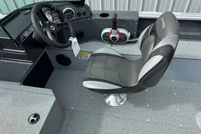 Slide: The Image of 2026 Lund 1800 Explorer Sport boat interior with steering wheel and cushioned seat. - 5