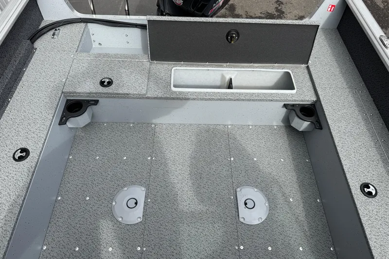 Slide: The Image of 2026 Lund 1800 Explorer Sport boat interior with storage compartments and fishing rod holders. - 9