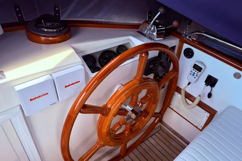 Slide: The Image of 1989 Grand Banks 32 Sedan helm with wooden wheel, Autohelm controls, and navigation instruments. - 14