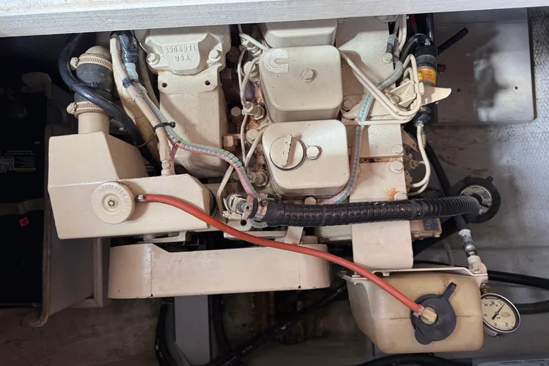 Slide: The Image of Engine compartment of a 1989 Grand Banks 32 Sedan boat, showcasing mechanical components. - 18