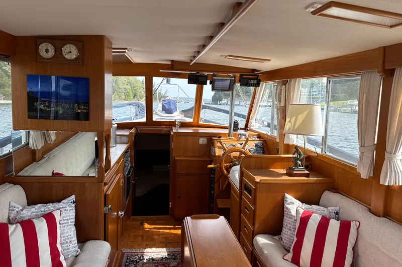 Slide: The Image of Interior of a 1989 Grand Banks 32 Sedan boat with wood finish and cozy seating. - 23
