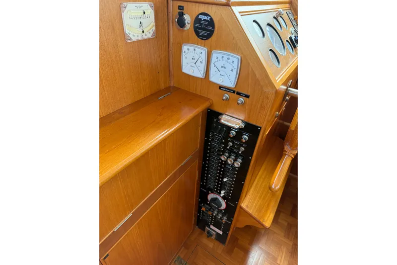 Slide: The Image of Control panel of a 1989 Grand Banks 32 Sedan boat with gauges and switches. - 7
