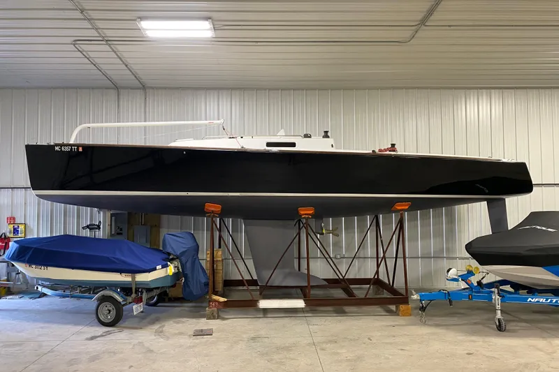 Slide: The Image of 2014 J Boats J/100 sailboat stored indoors on a stand. - 0