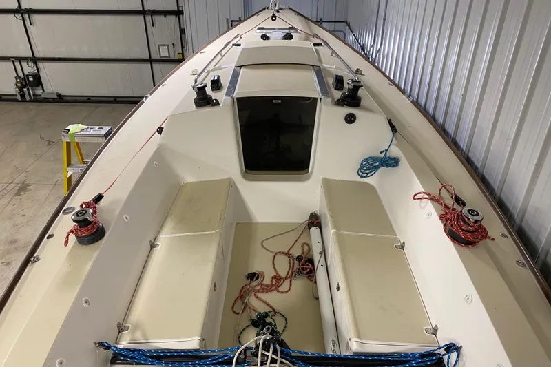 Slide: The Image of 2014 J Boats J/100 sailboat interior with ropes and winches in a storage facility. - 14
