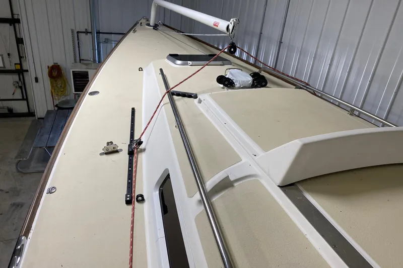Slide: The Image of 2014 J Boats J/100 sailboat deck in storage, featuring clean lines and rigging. - 15