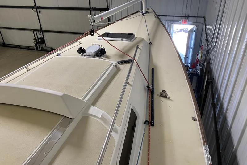 Slide: The Image of 2014 J Boats J/100 sailboat deck in storage, featuring rigging and hatch. - 16