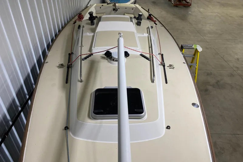 Slide: The Image of 2014 J Boats J/100 sailboat deck in storage, featuring clean lines and rigging. - 18