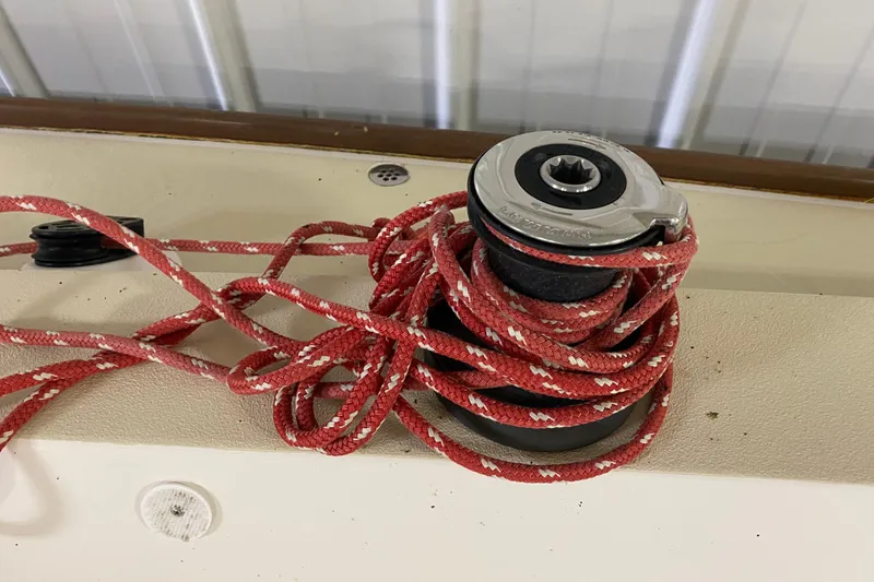 Slide: The Image of Red rope coiled around a winch on a 2014 J Boats J/100 sailboat. - 23