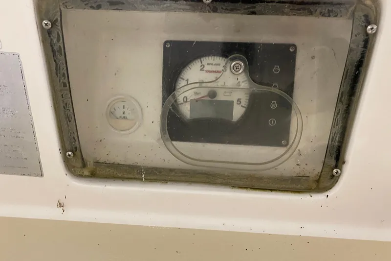 Slide: The Image of Instrument panel of a 2014 J Boats J/100, featuring fuel and RPM gauges. - 26