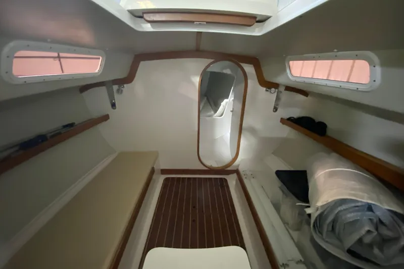 Slide: The Image of Interior of 2014 J Boats J/100 sailboat, featuring wooden accents and seating. - 29
