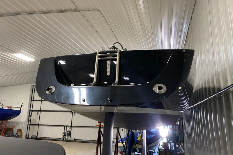 Slide: The Image of 2014 J Boats J/100 sailboat in indoor storage, viewed from the stern. - 3