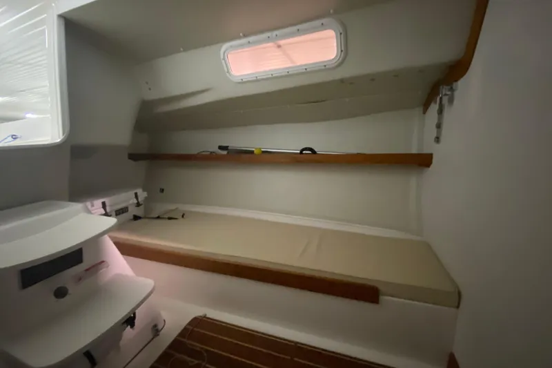 Slide: The Image of Interior cabin of 2014 J Boats J/100 sailboat with cushioned bench and shelving. - 31