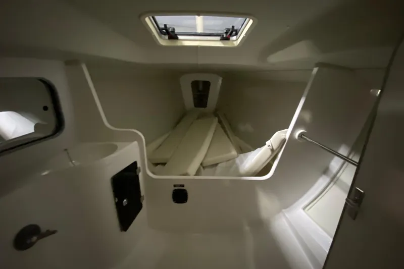 Slide: The Image of Interior cabin of 2014 J Boats J/100 sailboat, featuring compact design and storage space. - 32
