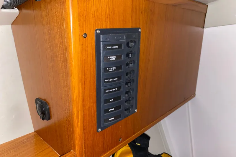 Slide: The Image of Control panel on 2014 J Boats J/100 sailboat, featuring labeled switches for various lights. - 43
