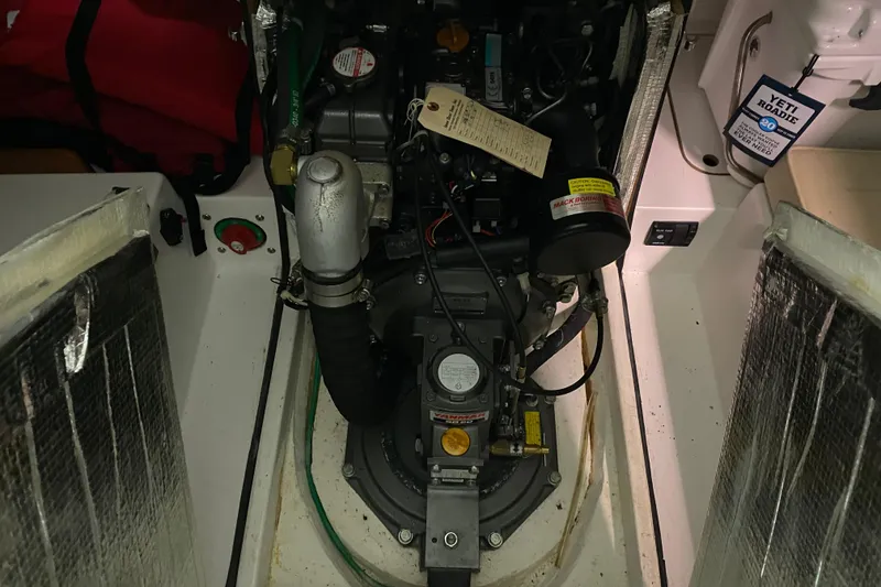 Slide: The Image of Engine compartment of a 2014 J Boats J/100 sailboat, showcasing mechanical components. - 49