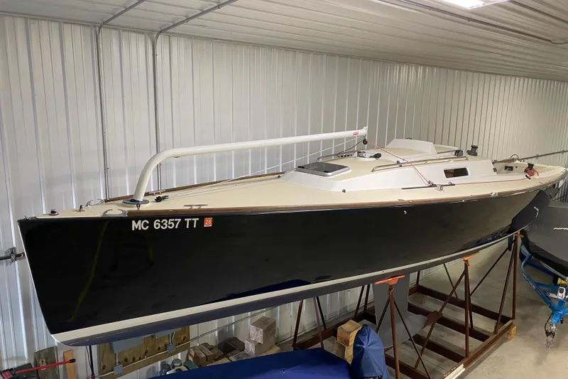 Slide: The Image of 2014 J Boats J/100 sailboat in indoor storage, black hull, white deck. - 5