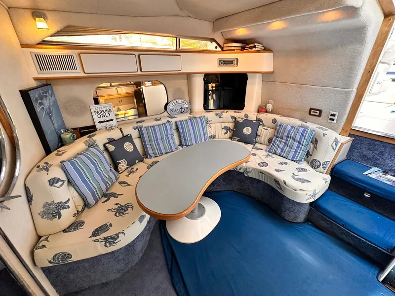 Slide: The Image of Interior of 1992 Sea Ray 400 Express Cruiser with cozy seating and nautical decor. - 10