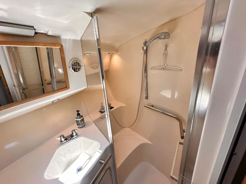 Slide: The Image of 1992 Sea Ray 400 Express Cruiser bathroom with shower, sink, and mirror. - 18