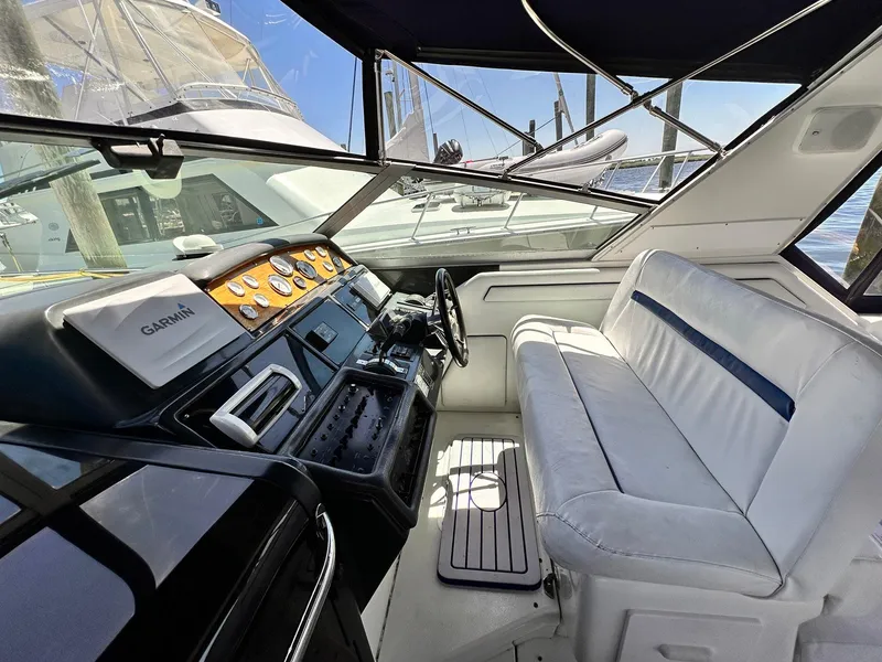 Slide: The Image of 1992 Sea Ray 400 Express Cruiser cockpit with white seating and navigation controls. - 6