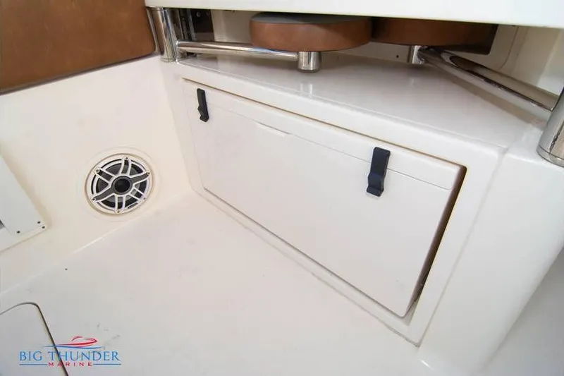 Slide: The Image of 2022 Scout 350 LXZ boat interior with storage compartment and speaker. - 25
