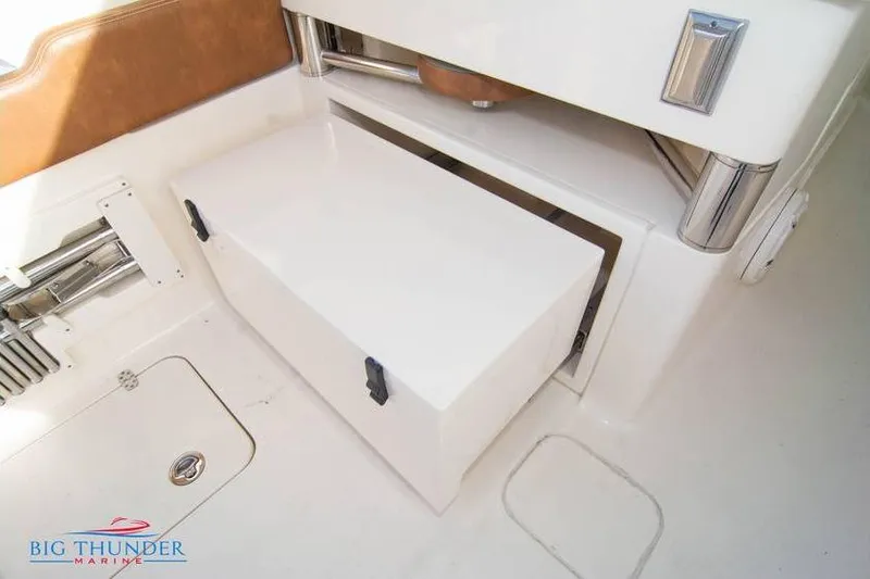Slide: The Image of 2022 Scout 350 LXZ boat interior storage compartment with sleek design and secure latches. - 26