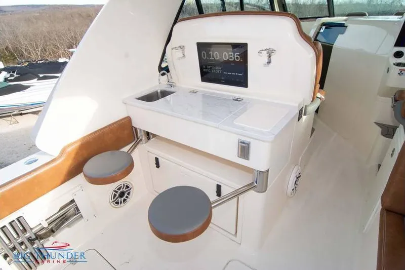 Slide: The Image of 2022 Scout 350 LXZ boat interior with seating, sink, and control panel. - 27
