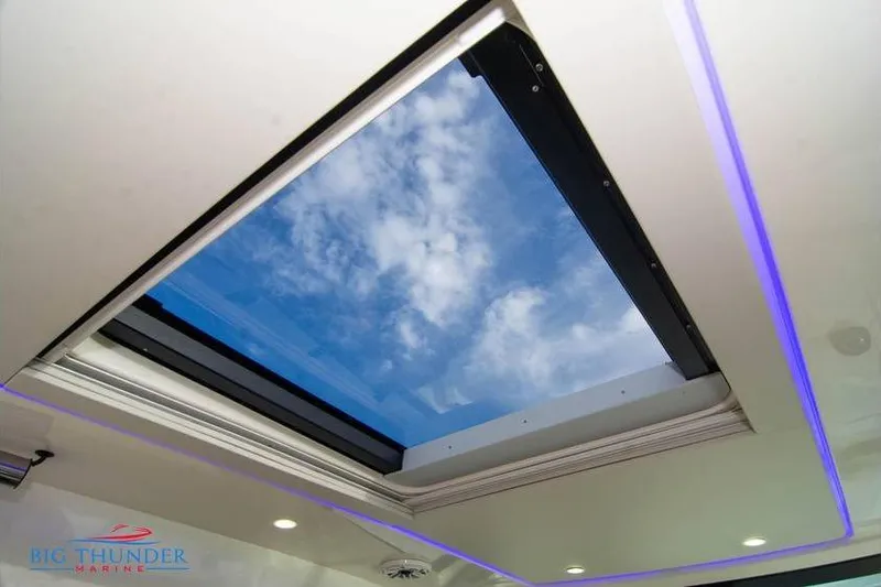 Slide: The Image of 2022 Scout 350 LXZ boat skylight with blue sky view. - 34