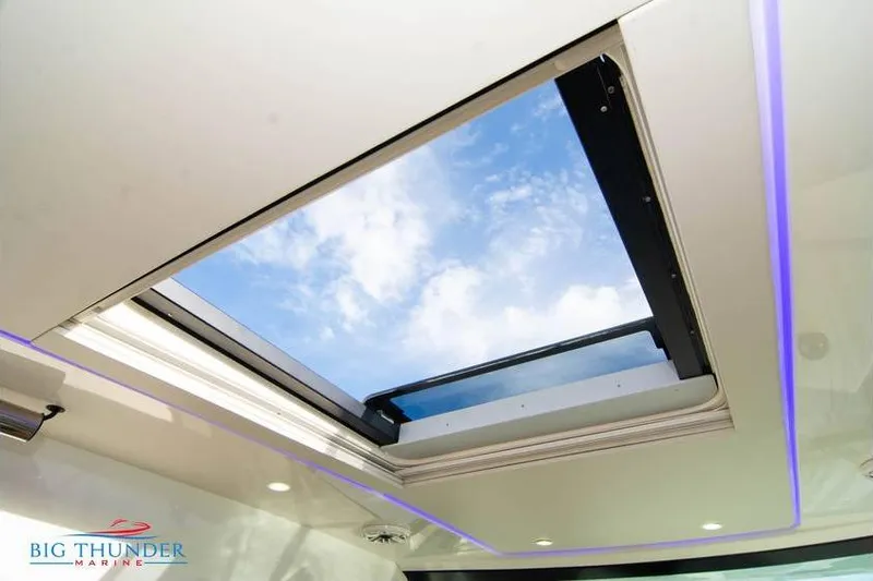 Slide: The Image of 2022 Scout 350 LXZ boat skylight with blue sky view. - 35
