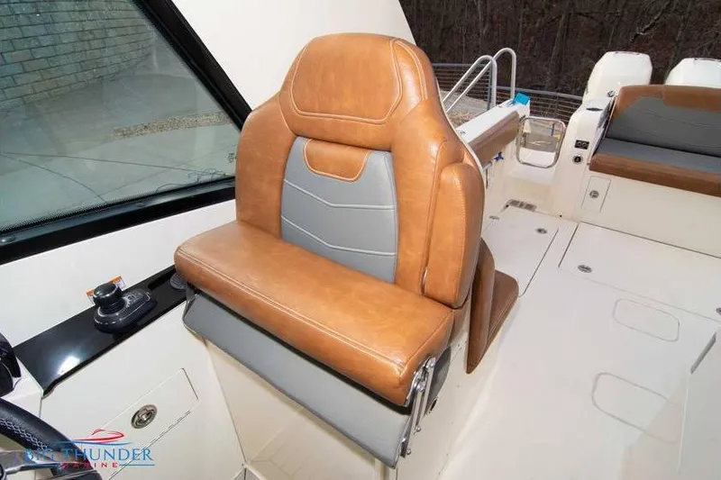 Slide: The Image of 2022 Scout 350 LXZ boat with luxurious tan and gray seating. - 36