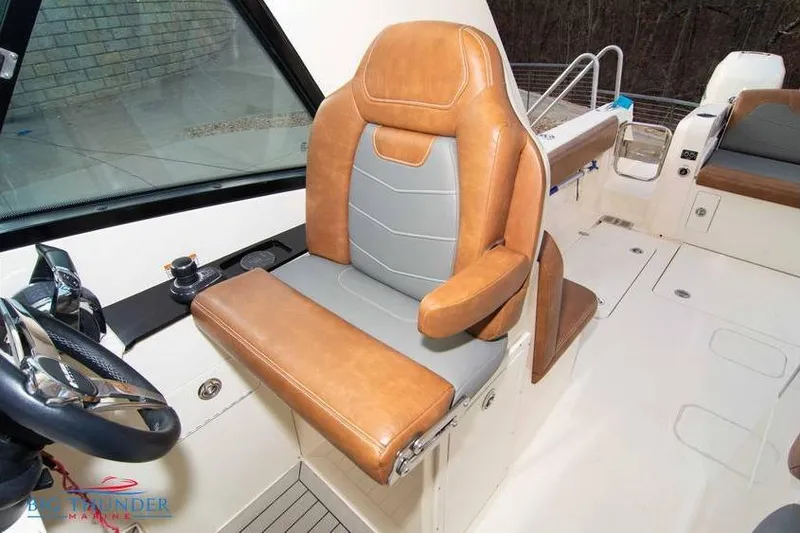 Slide: The Image of 2022 Scout 350 LXZ boat interior with tan and gray captain's seat. - 37