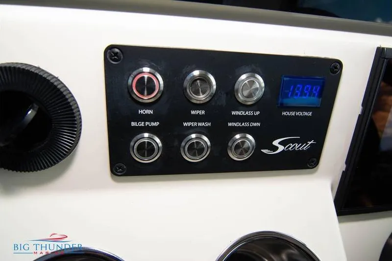 Slide: The Image of Control panel of 2022 Scout 350 LXZ boat with various switches and voltage display. - 42