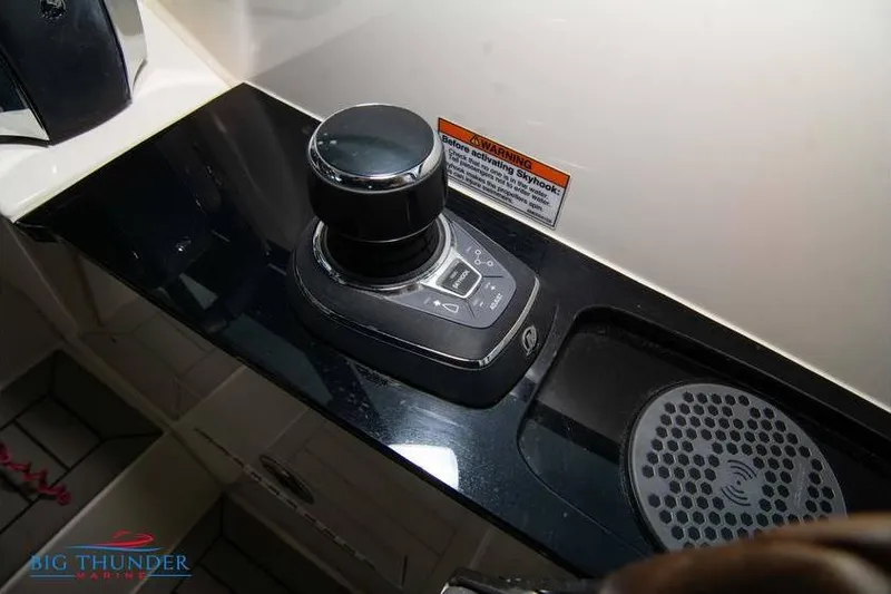 Slide: The Image of Control panel of 2022 Scout 350 LXZ boat with joystick and warning label. - 44