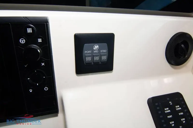 Slide: The Image of Control panel of 2022 Scout 350 LXZ boat with start/stop buttons and dials. - 45