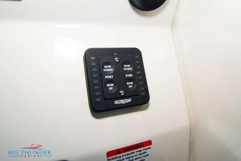Slide: The Image of Control panel of 2022 Scout 350 LXZ boat with Lectrotab trim tab switches. - 47