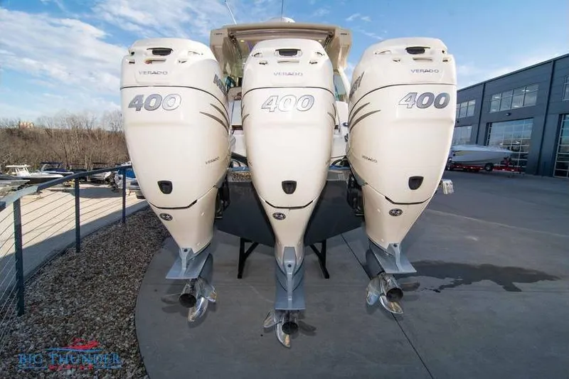 Slide: The Image of 2022 Scout 350 LXZ boat with triple 400 Verado engines at a marina. - 5