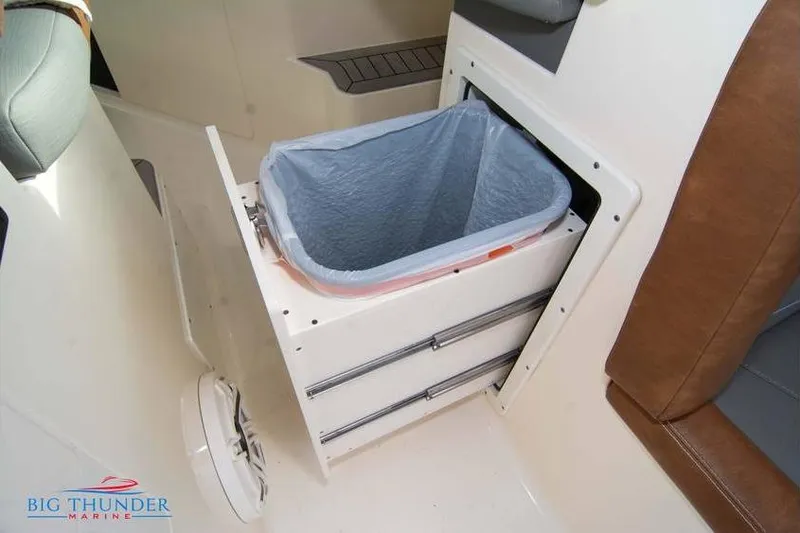 Slide: The Image of 2022 Scout 350 LXZ boat interior with built-in trash compartment. - 50