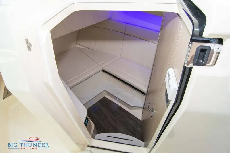 Slide: The Image of 2022 Scout 350 LXZ cabin interior with modern seating and ambient lighting. - 52