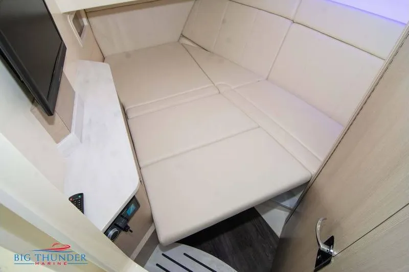 Slide: The Image of 2022 Scout 350 LXZ cabin interior with beige seating and modern amenities. - 54