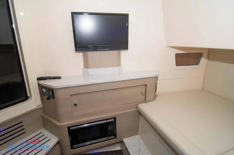 Slide: The Image of Interior of 2022 Scout 350 LXZ boat with TV, microwave, and seating area. - 55