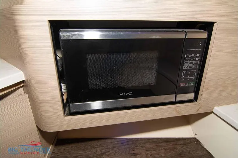 Slide: The Image of Built-in microwave in 2022 Scout 350 LXZ boat interior. - 58