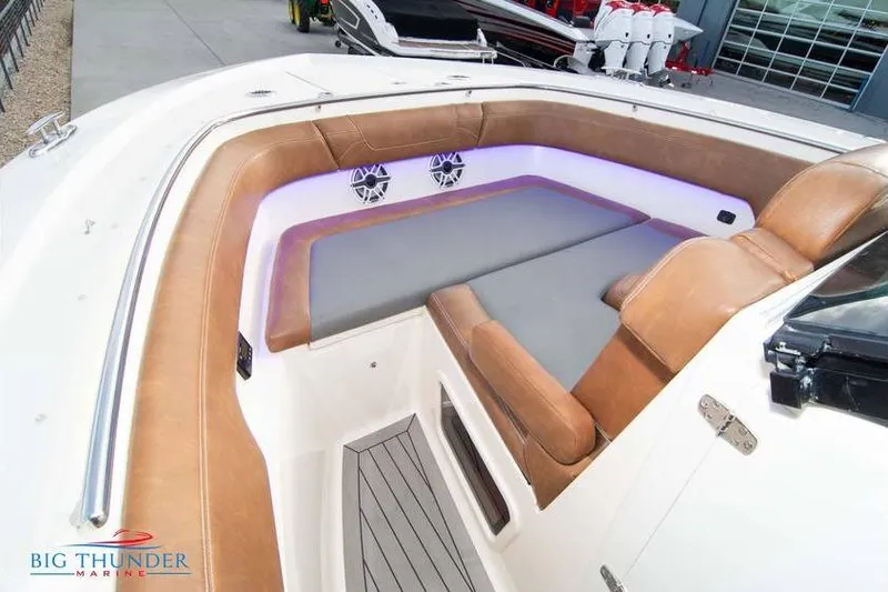 Slide: The Image of 2022 Scout 350 LXZ boat interior with tan seating and LED lighting. - 63